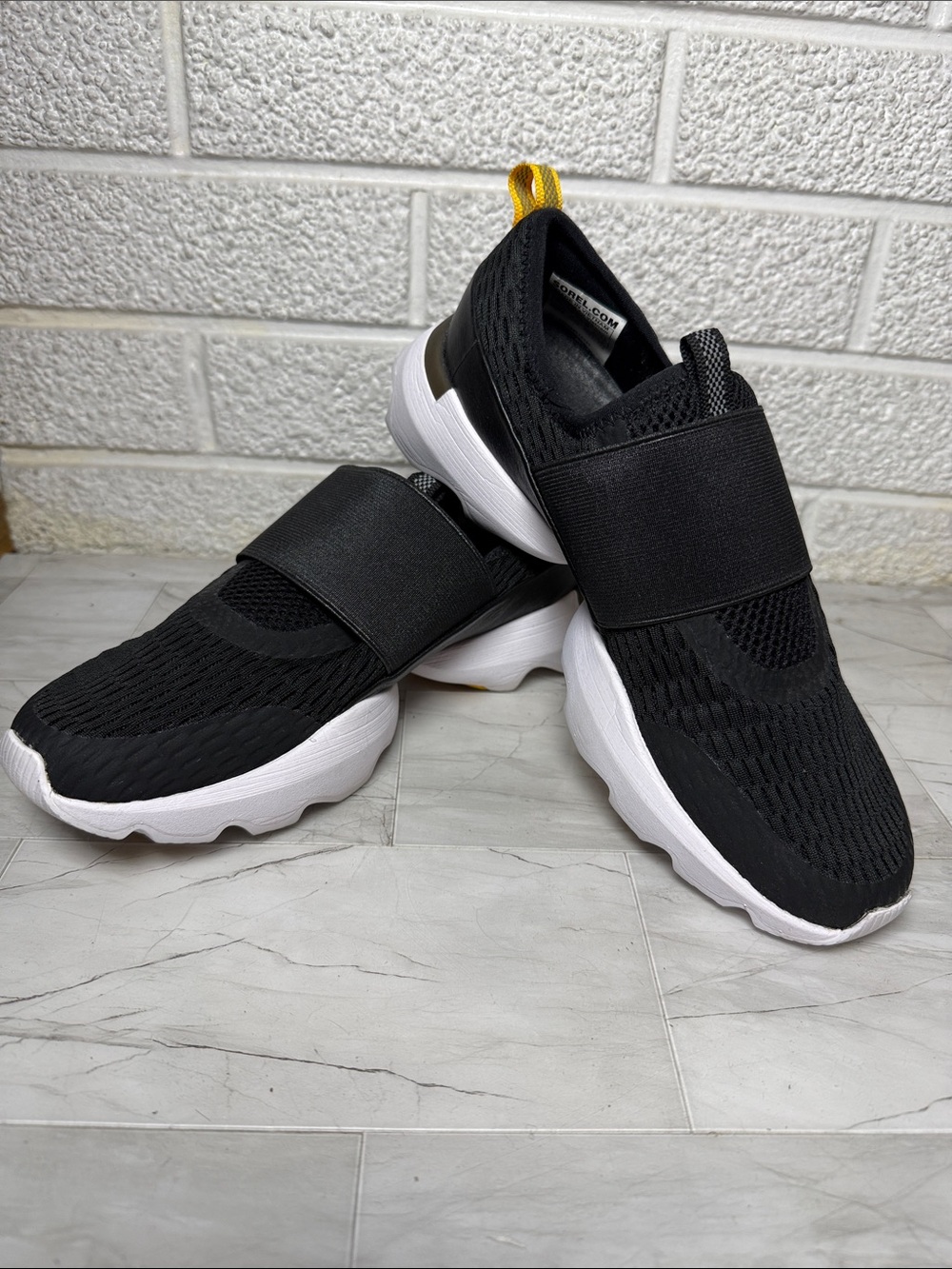 Sorel Kinetic Impact Strap Shoe: Black Slip-On Knit Sneakers with White Sole